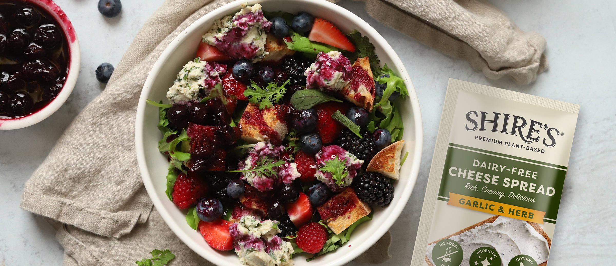 Field green salad with berries and Shire's Dairy-Free Cheese Spread